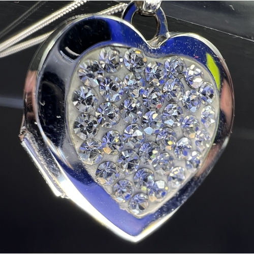699 - A 9ct gold heart shaped locket set with crystals on chain