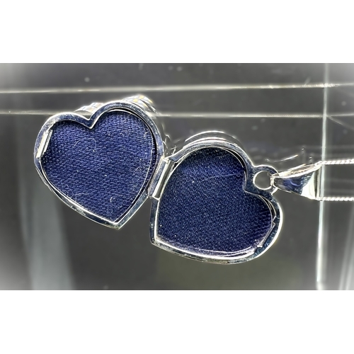 699 - A 9ct gold heart shaped locket set with crystals on chain