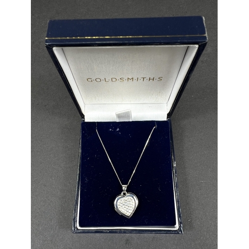 699 - A 9ct gold heart shaped locket set with crystals on chain