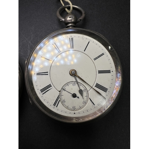 712 - Two silver cased open faced pocket watches and a vintage stopwatch
