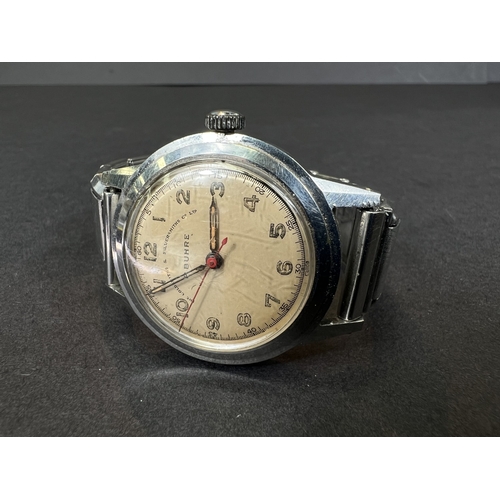 713 - A mid 20th century P. Buhre steel cased gents watch, dedication to the reverse