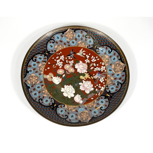 548 - A 19th century Japanese cloisonné dish decorated with birds and flowers in colour enamels, 30cm