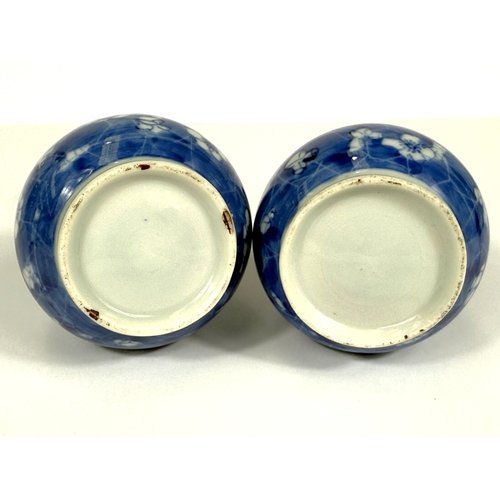 549 - A pair of oriental porcelain baluster vases decorated in underglaze blue with prunus blossom on crac... 