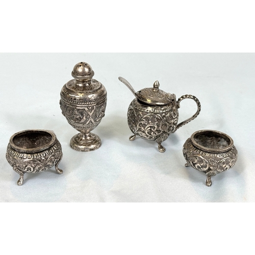 607 - An Indian white metal 4 piece cruet set with embossed decoration (tests silver)