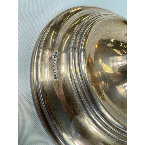 672 - A pair of hallmarked silver candlesticks with ribbed decoration, London 1969, weighted base