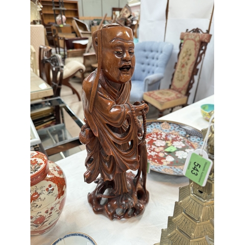 542 - A Chinese 19th century carved hardwood figure of a mendicant, 37cm
