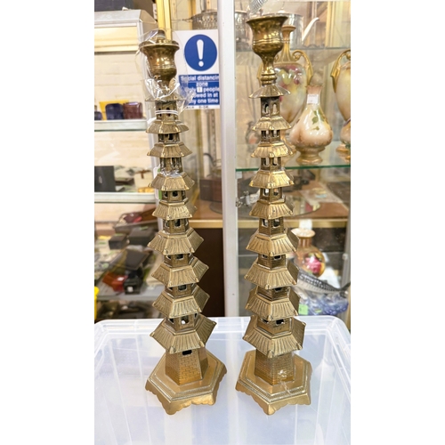 543 - A pair of Chinese 19th century brass pagoda candlesticks, 37cm (one top altered)