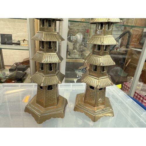 543 - A pair of Chinese 19th century brass pagoda candlesticks, 37cm (one top altered)