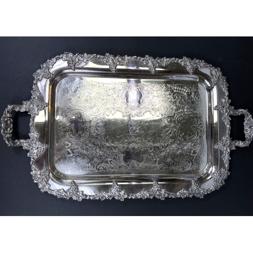 614 - A large silver plated tray with grapevine border and double handles, 64cm