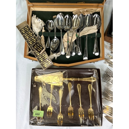 668 - A collection of boxed and loose cutlery.