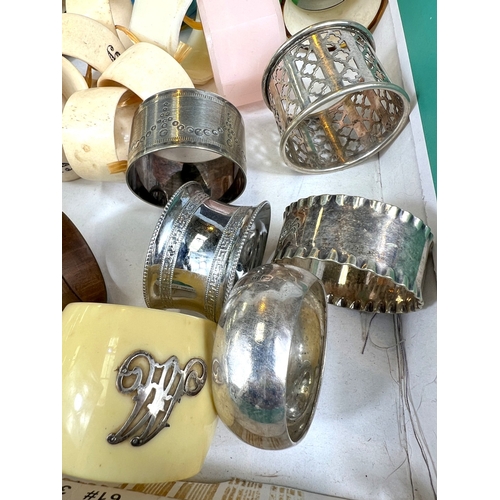 670 - A collection of silver, white metal and other napkin rings.