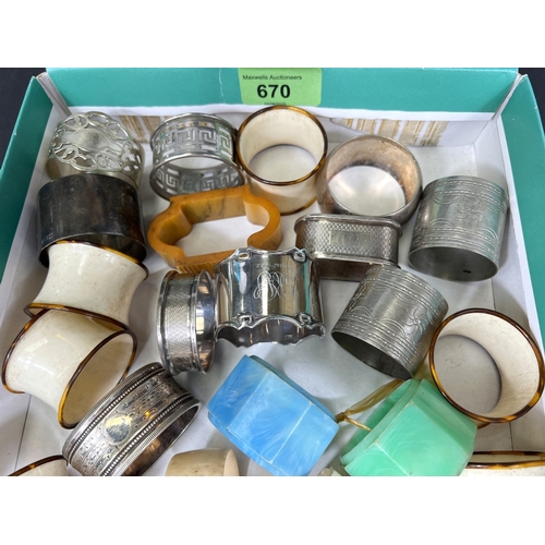 670 - A collection of silver, white metal and other napkin rings.