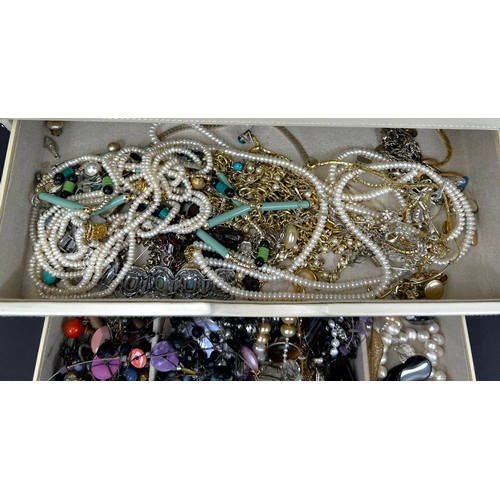701 - A stacking jewellery box in white with items of costume jewellery