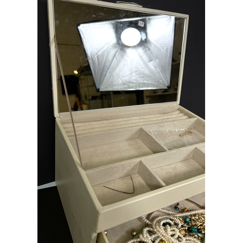 701 - A stacking jewellery box in white with items of costume jewellery