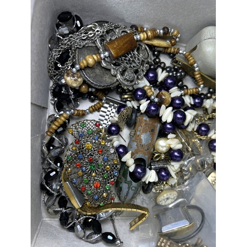 702 - A selection of costume jewellery beads brooches etc