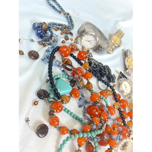 704 - A collection of watches, costume beads etc
