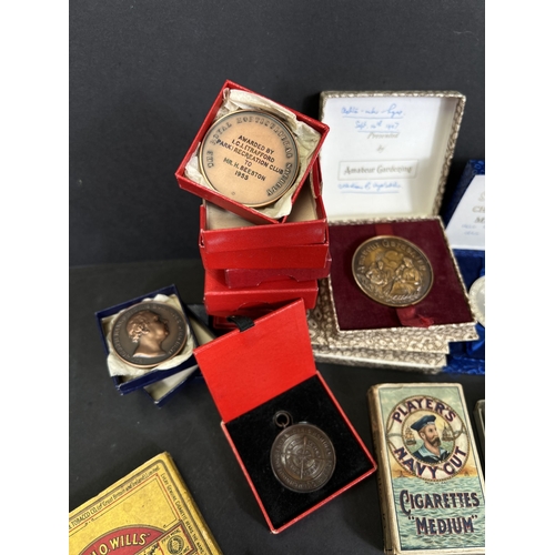 711 - A collection of post war Small holding medals bronze, costume, cigarette cards etc