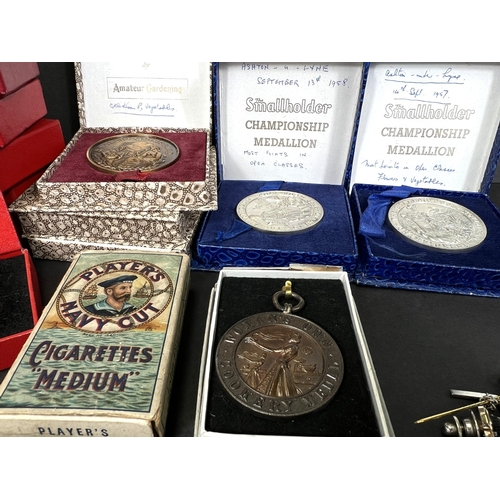 711 - A collection of post war Small holding medals bronze, costume, cigarette cards etc