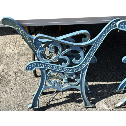 173 - Two pairs of cast iron bench ends.