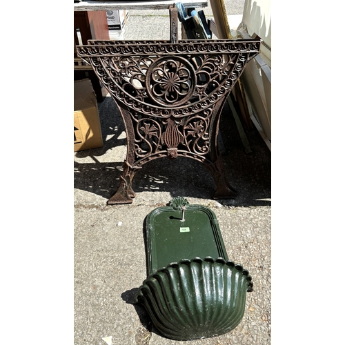 188 - A classical style modern cast metal wall hanging planter and a pair of cast iron bench ends.
