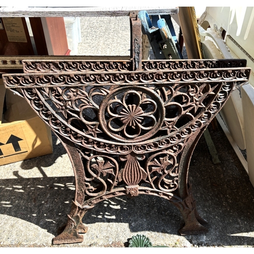 188 - A classical style modern cast metal wall hanging planter and a pair of cast iron bench ends.