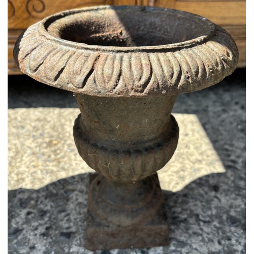 190 - A cast iron classical style garden planter and a similar smaller.