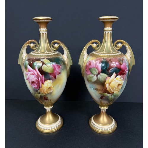 529 - Royal Worcester, a pair of hand painted vases, ovoid with double handles and pedestal, roses on ivor... 