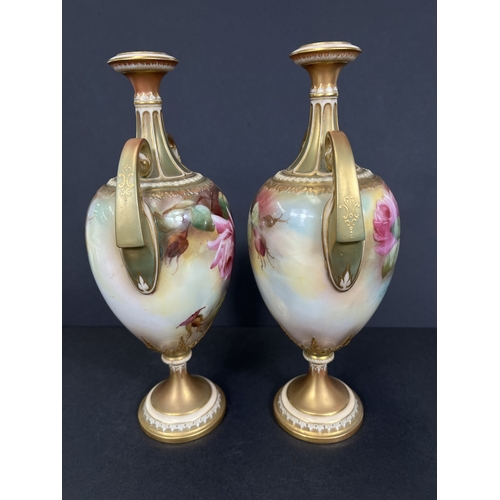 529 - Royal Worcester, a pair of hand painted vases, ovoid with double handles and pedestal, roses on ivor... 
