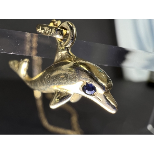715A - A yellow metal dolphin pendant on necklace, dolphin stamped 585 and necklace stamped Midas 14K gross... 