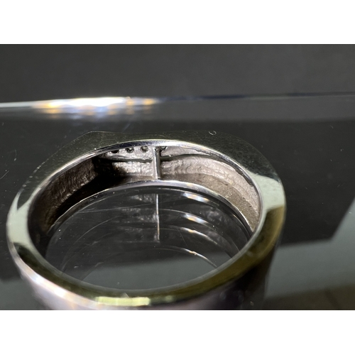 716 - An 18ct white gold wedding band set with four small diamonds, 6.8gms
