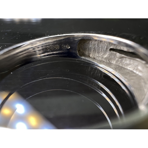 716 - An 18ct white gold wedding band set with four small diamonds, 6.8gms
