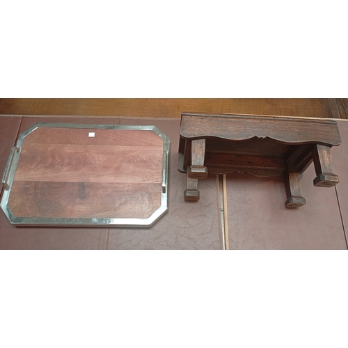 746 - A small oak footstool; an Art Deco style canted rectangular tray with silver plated rim and handles.