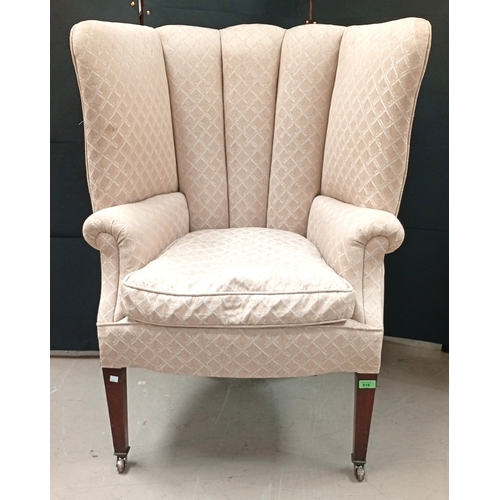 816 - An Art Deco high back tub armchair with fawn upholstery, mahogany tapering legs.