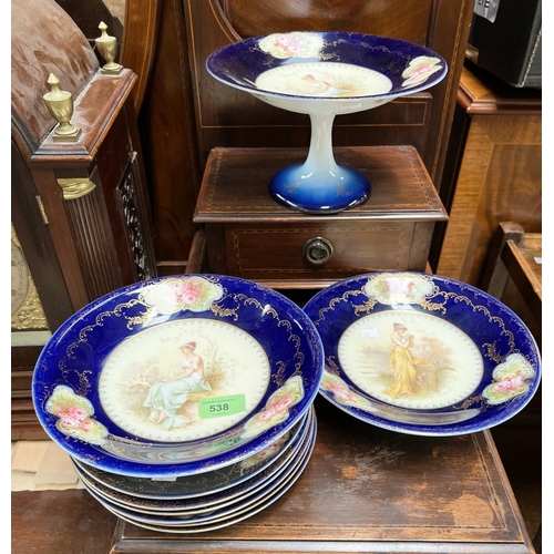 538 - A Limoges style dessert service decorated with females to centre, blue and gilt decoration, 9 pieces... 