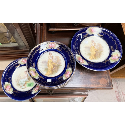 538 - A Limoges style dessert service decorated with females to centre, blue and gilt decoration, 9 pieces... 
