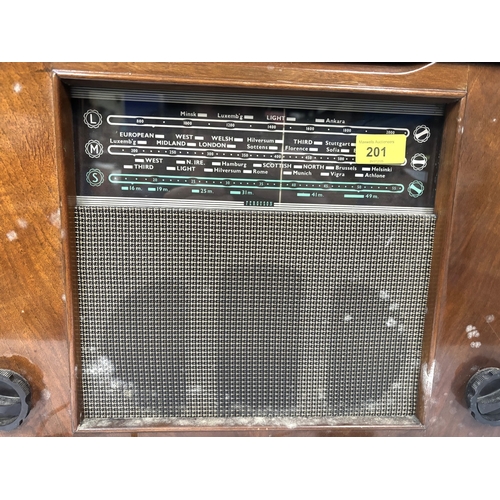 84 - A mid 20th century walnut table top radio with record player; a mahogany circular wall clock.