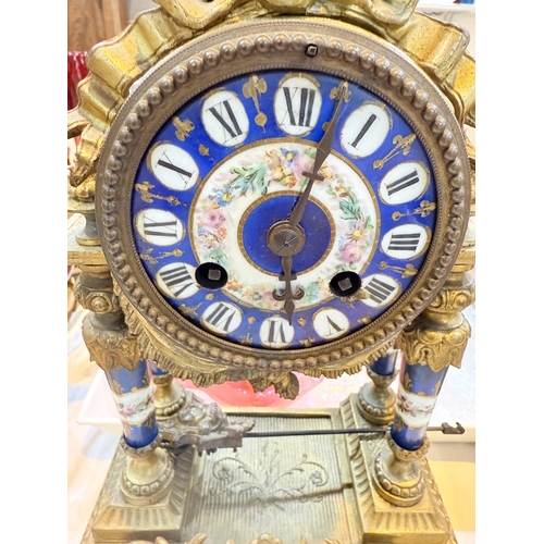 94A - A 19th century Louis XVI style ormolu  and porcelain mantle clock with vase finial, drum shaped cloc... 