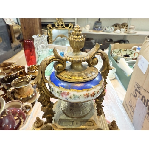 94A - A 19th century Louis XVI style ormolu  and porcelain mantle clock with vase finial, drum shaped cloc... 