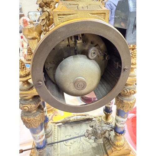 94A - A 19th century Louis XVI style ormolu  and porcelain mantle clock with vase finial, drum shaped cloc... 
