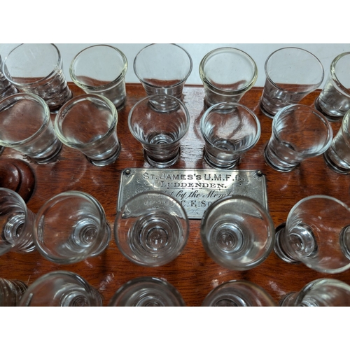 34 - An early 20th century Methodist Communion tray with forty small glasses, and plaque for St James's U... 