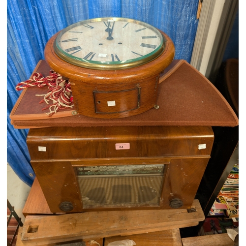 84 - A mid 20th century walnut table top radio with record player; a mahogany circular wall clock.