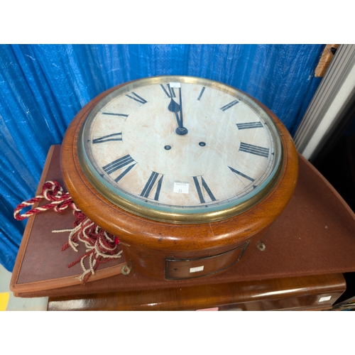 84 - A mid 20th century walnut table top radio with record player; a mahogany circular wall clock.