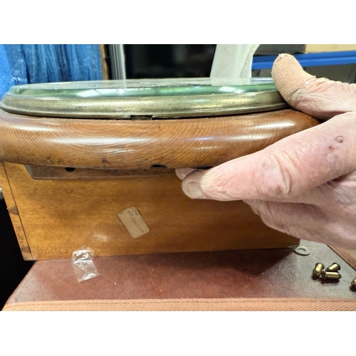 84 - A mid 20th century walnut table top radio with record player; a mahogany circular wall clock.