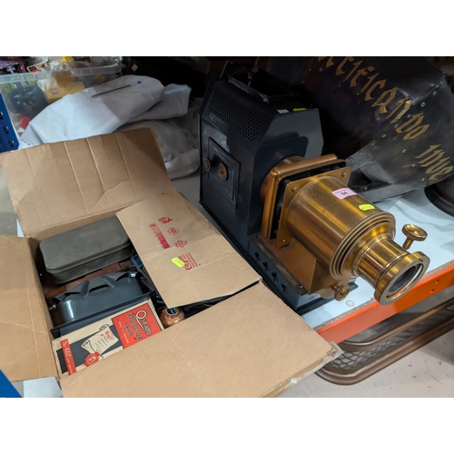 94 - A Victorian metal magic lantern with accessories.