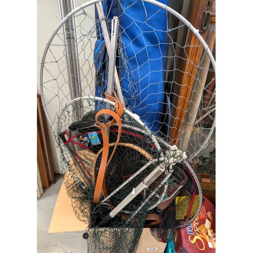37 - A bag with fishing rods in tubes, various large fishing nets (wood and metal), and a shooting stick....