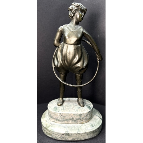 31 - An Art Deco bronzed figure depicting a girl with a hoop, on a two-tier marble stand, height 20cm....