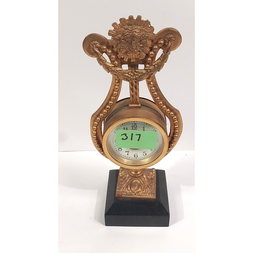 22 - A French gilt ormalou clock in the shape of a harp...