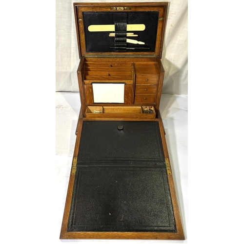1 - An oak fall front writing box with fitted interior and a brass trivet....