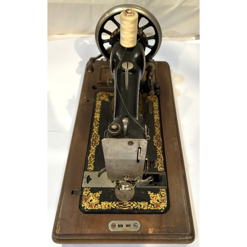 13 - A hand operated sewing machine....