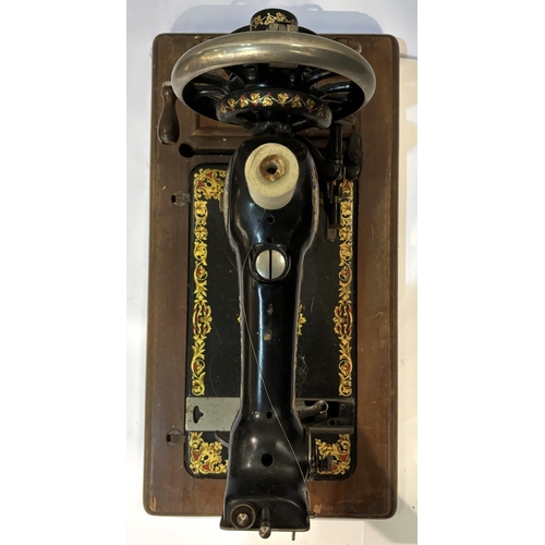 13 - A hand operated sewing machine....